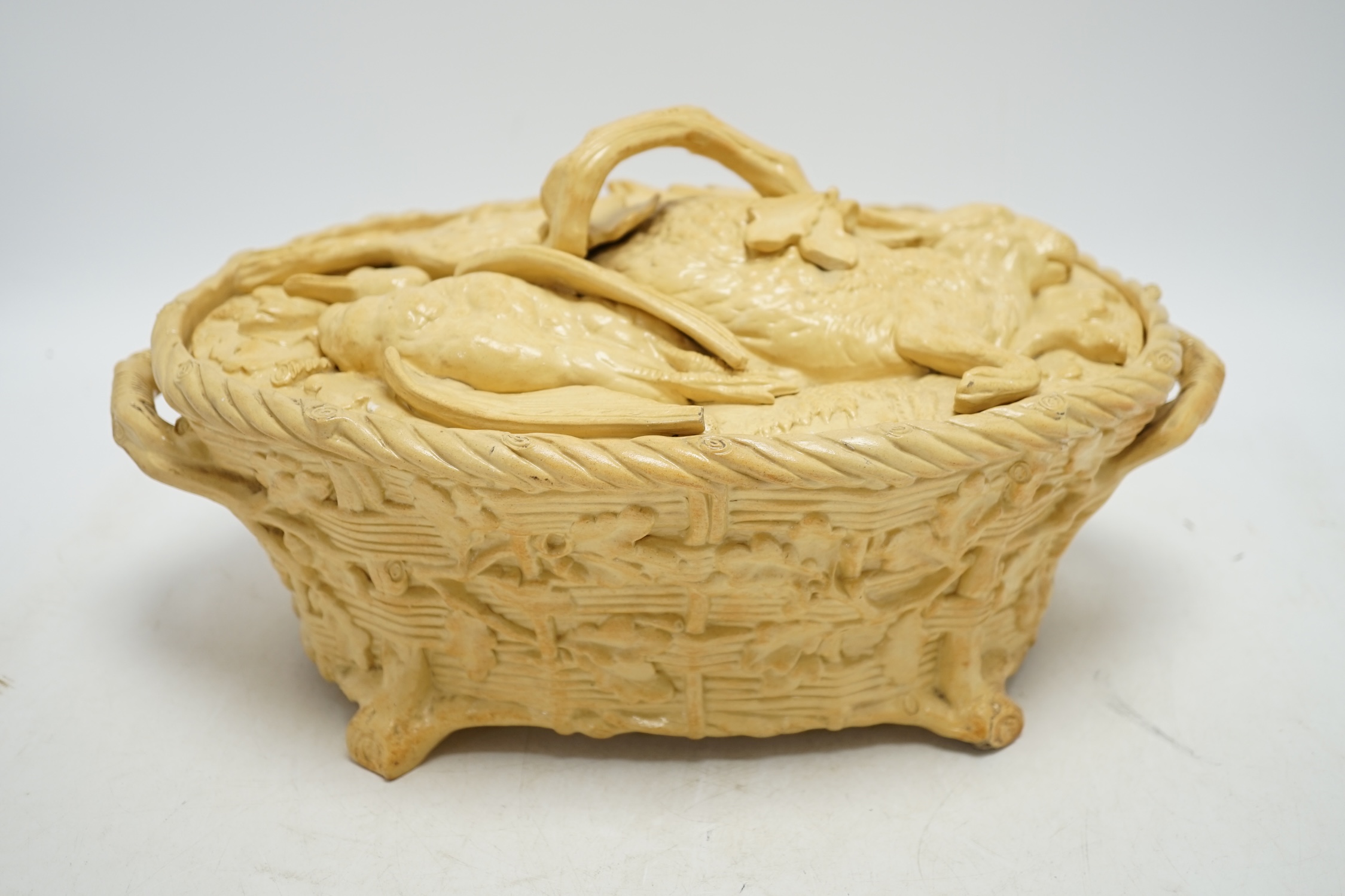 A 19th century Minton caneware game pie dish and cover, 33cm wide. Condition - acorn leaf tip and wing tip missing on cover, small chips to inner lip of tureen.
